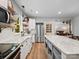 Spacious kitchen with stainless appliances, white cabinets, and an island with countertop seating at 6758 Zion Church Rd, Concord, NC 28025