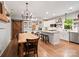 Spacious kitchen and dining area with island, modern lighting, and wooden table at 6758 Zion Church Rd, Concord, NC 28025