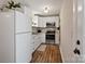 Functional kitchen features white cabinetry, stainless steel appliances, and hardwood floors for a clean and efficient space at 6758 Zion Church Rd, Concord, NC 28025