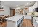 Large kitchen with a central island, white cabinets, granite counters and dining space nearby at 6758 Zion Church Rd, Concord, NC 28025