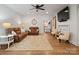 Cozy living room with hardwood floors, ceiling fan, and comfortable seating area at 6758 Zion Church Rd, Concord, NC 28025