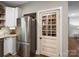 Well-stocked pantry with stainless fridge and custom painted door featuring shelves of food at 6758 Zion Church Rd, Concord, NC 28025