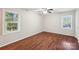 Well-lit bedroom featuring hardwood floors, ceiling fan, and a double window for natural light at 6807 Woodfield Dr, Charlotte, NC 28215