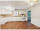 Modern kitchen with white cabinetry, updated appliances, and sleek hardwood floors at 6807 Woodfield Dr, Charlotte, NC 28215