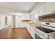 Bright kitchen featuring white cabinets, stainless steel appliances, and tiled backsplash at 6807 Woodfield Dr, Charlotte, NC 28215