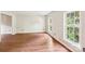 Bright, spacious room with hardwood floors and two large windows for natural light at 6807 Woodfield Dr, Charlotte, NC 28215