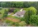 An aerial view of a beautiful home with lush green lawns, trees, and lake access at 7471 Barfield Ln, Denver, NC 28037