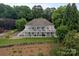 Aerial view of the home with a covered balcony, extensive landscaping, and backyard at 7471 Barfield Ln, Denver, NC 28037