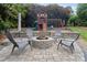 Beautiful backyard featuring a fire pit with Adirondack chairs and a charming play set at 7471 Barfield Ln, Denver, NC 28037