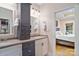 Well-lit bathroom features a double sink vanity, a tower for storage, and leads to the main bedroom at 7471 Barfield Ln, Denver, NC 28037
