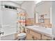 Bright bathroom featuring tile floors, a shower with dinosaur curtain, and a vanity with charming hardware at 7471 Barfield Ln, Denver, NC 28037