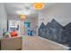 A cozy bedroom featuring neutral walls, bright lighting, and playful chalkboard mountain range on the wall at 7471 Barfield Ln, Denver, NC 28037