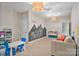 The bedroom has fun elements like an interactive chalkboard wall, play table, and bookshelves at 7471 Barfield Ln, Denver, NC 28037