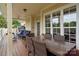 Inviting covered patio with a dining table, comfortable seating, and views of the outdoor area at 7471 Barfield Ln, Denver, NC 28037
