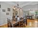 Elegant dining room with a wooden table, stylish lighting, and hardwood floors, perfect for hosting memorable dinners at 7471 Barfield Ln, Denver, NC 28037