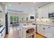 Bright kitchen with a central island, granite countertops, stainless steel appliances, and ample storage space, ideal for cooking and entertaining at 7471 Barfield Ln, Denver, NC 28037