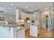 Bright kitchen featuring white cabinetry, granite countertops, stainless steel appliances, and hardwood floors, perfect for culinary enthusiasts at 7471 Barfield Ln, Denver, NC 28037