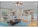 Cozy living room featuring hardwood floors and neutral paint, with a view to the kitchen at 7471 Barfield Ln, Denver, NC 28037