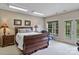 Bright main bedroom with a bed, dresser, desk and ensuite bathroom with lots of natural light at 7471 Barfield Ln, Denver, NC 28037