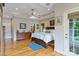 Spacious main bedroom with hardwood floors, a tray ceiling, and a comfortable king-size bed with stylish blue accents at 7471 Barfield Ln, Denver, NC 28037