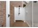 This backyard features a private outdoor shower enclosed by brick and white fencing at 7471 Barfield Ln, Denver, NC 28037
