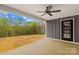 Covered back porch featuring a ceiling fan and an exit door, with views of the outdoors at 750 Whites Farm Rd, Statesville, NC 28625