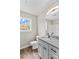 Bright bathroom with vanity, granite countertop, decorative mirror, toilet and window at 750 Whites Farm Rd, Statesville, NC 28625