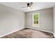 Bright bedroom with wood-look flooring, a ceiling fan, and a window offering natural light at 750 Whites Farm Rd, Statesville, NC 28625