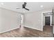 Comfortable bedroom with wood-look floors, ceiling fan and neutral paint at 750 Whites Farm Rd, Statesville, NC 28625