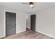 Bedroom with two doors, wood-look flooring, neutral walls, and a ceiling fan at 750 Whites Farm Rd, Statesville, NC 28625