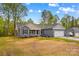 Charming single-story home with a two-car garage and neutral-colored siding in a serene, wooded setting at 750 Whites Farm Rd, Statesville, NC 28625