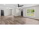 Bright living room featuring new flooring, fresh paint, and contemporary ceiling fan at 750 Whites Farm Rd, Statesville, NC 28625