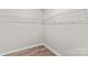 Efficient walk-in closet with white wire shelving and wood-look flooring at 750 Whites Farm Rd, Statesville, NC 28625
