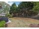 A grassy backyard with a fence line and large trees providing privacy and shade at 8200 Sunset Hill Rd, Waxhaw, NC 28173