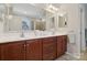 Bathroom features double sink vanity with wooden cabinets and a large mirror at 8200 Sunset Hill Rd, Waxhaw, NC 28173