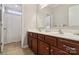 Bathroom featuring double sinks with wood cabinets and a tiled floor at 8200 Sunset Hill Rd, Waxhaw, NC 28173