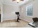 Bright bedroom featuring hardwood floors, neutral walls, a ceiling fan, and a stationary bicycle at 8200 Sunset Hill Rd, Waxhaw, NC 28173