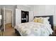 Well-lit bedroom highlights a stylish bed, closet with open doors, and modern décor, creating a welcoming retreat at 8200 Sunset Hill Rd, Waxhaw, NC 28173