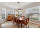 Bright dining room showcases a wooden table, seating for eight, and natural light, complemented by decorative window blinds at 8200 Sunset Hill Rd, Waxhaw, NC 28173