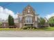 Attractive stone building boasts a balcony, arched entryway and manicured landscaping under a blue sky at 8200 Sunset Hill Rd, Waxhaw, NC 28173