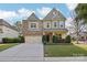 Charming two-story home with a manicured lawn and a two-car garage at 8200 Sunset Hill Rd, Waxhaw, NC 28173
