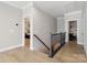 Hallway with hardwood floors and wrought iron stair railing leading to the bedrooms at 8200 Sunset Hill Rd, Waxhaw, NC 28173