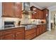 Well lit kitchen showcases granite countertops and stainless steel appliances, including a professional-grade stovetop and range hood at 8200 Sunset Hill Rd, Waxhaw, NC 28173