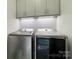 Laundry room featuring a modern washer, dryer, gray cabinets, and a stylish backsplash at 8200 Sunset Hill Rd, Waxhaw, NC 28173