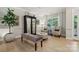 Bright living room with a decorative glass display cabinet and bench seating at 8200 Sunset Hill Rd, Waxhaw, NC 28173
