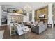 Spacious living room with soaring ceilings, stone fireplace and multiple seating areas at 8200 Sunset Hill Rd, Waxhaw, NC 28173