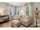 Comfortable living room showcases two armchairs, an ottoman, and decorative accents at 8200 Sunset Hill Rd, Waxhaw, NC 28173