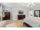 Spacious main bedroom offers ample natural light and is complemented by dual dressers and wood flooring at 8200 Sunset Hill Rd, Waxhaw, NC 28173