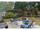 Relaxing backyard patio with comfortable seating, an umbrella, and a decorative striped rug at 8200 Sunset Hill Rd, Waxhaw, NC 28173