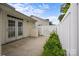 Enclosed backyard patio area with privacy fence and greenery at 8313 Carob Tree Ln, Charlotte, NC 28215